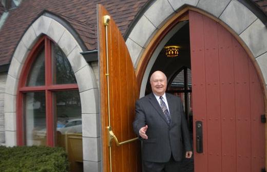 Pastor Weigle opening church door and offering a handshake
